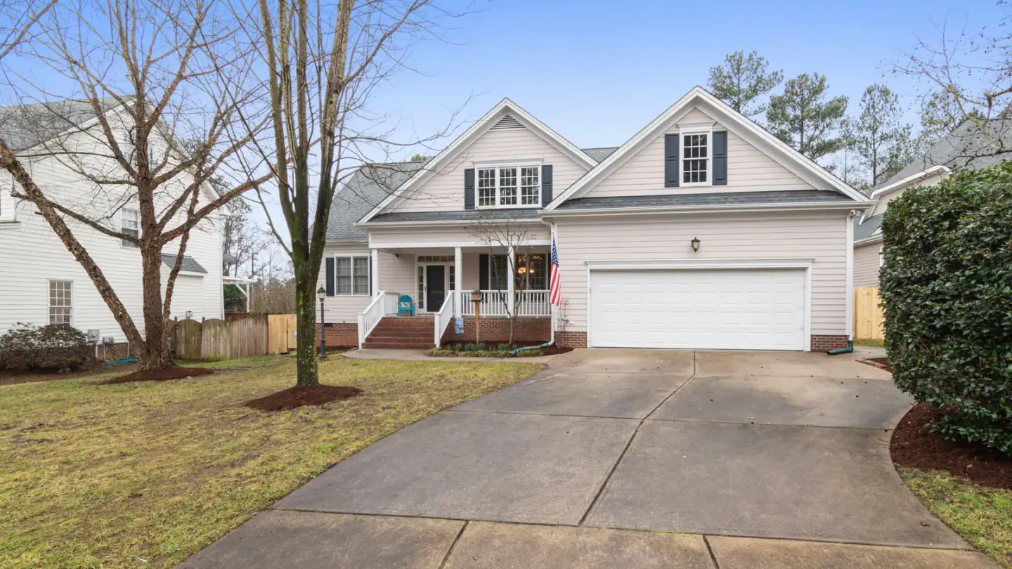Detached suburban home with a wide driveway and garage