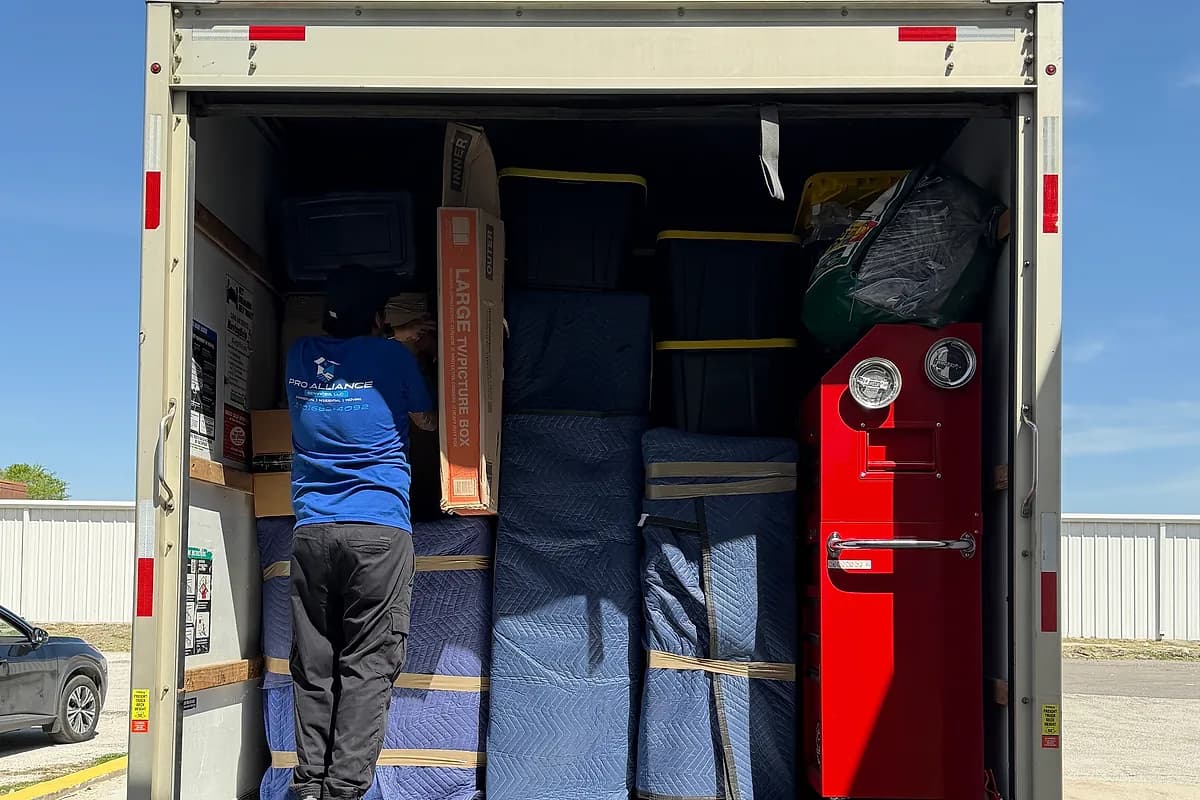 Pro Alliance moving truck with the ramp set at a residential loading area