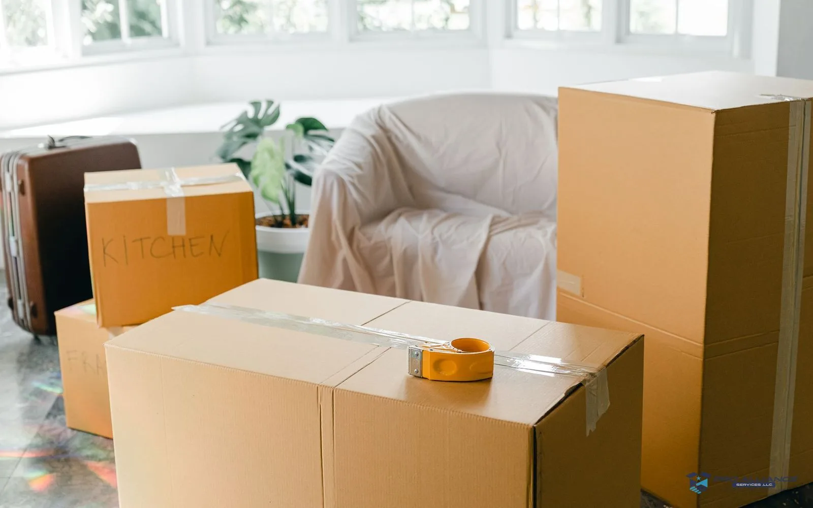 Moving boxes stacked by the door of an emptied apartment