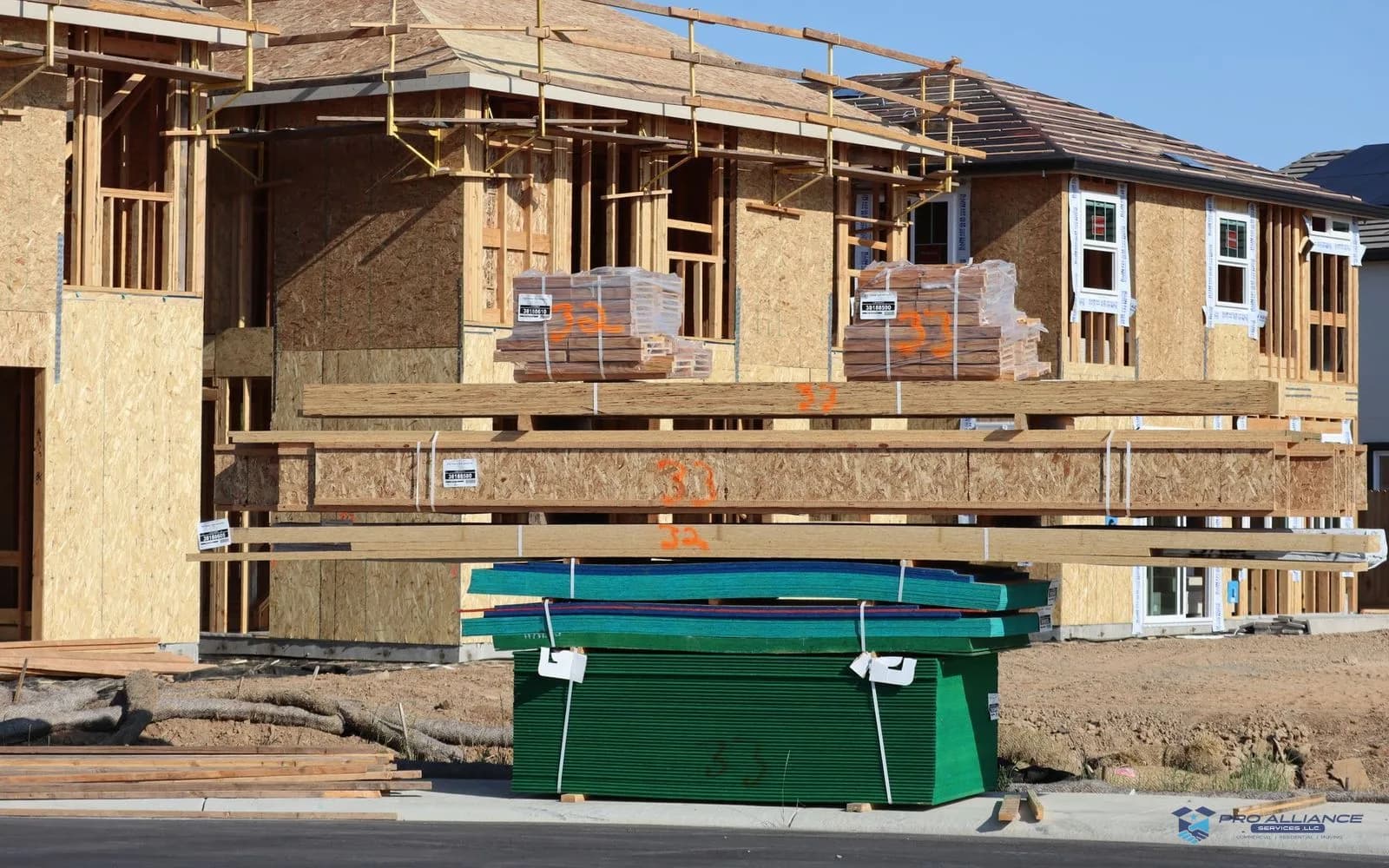 New single-family homes under construction along a subdivision street