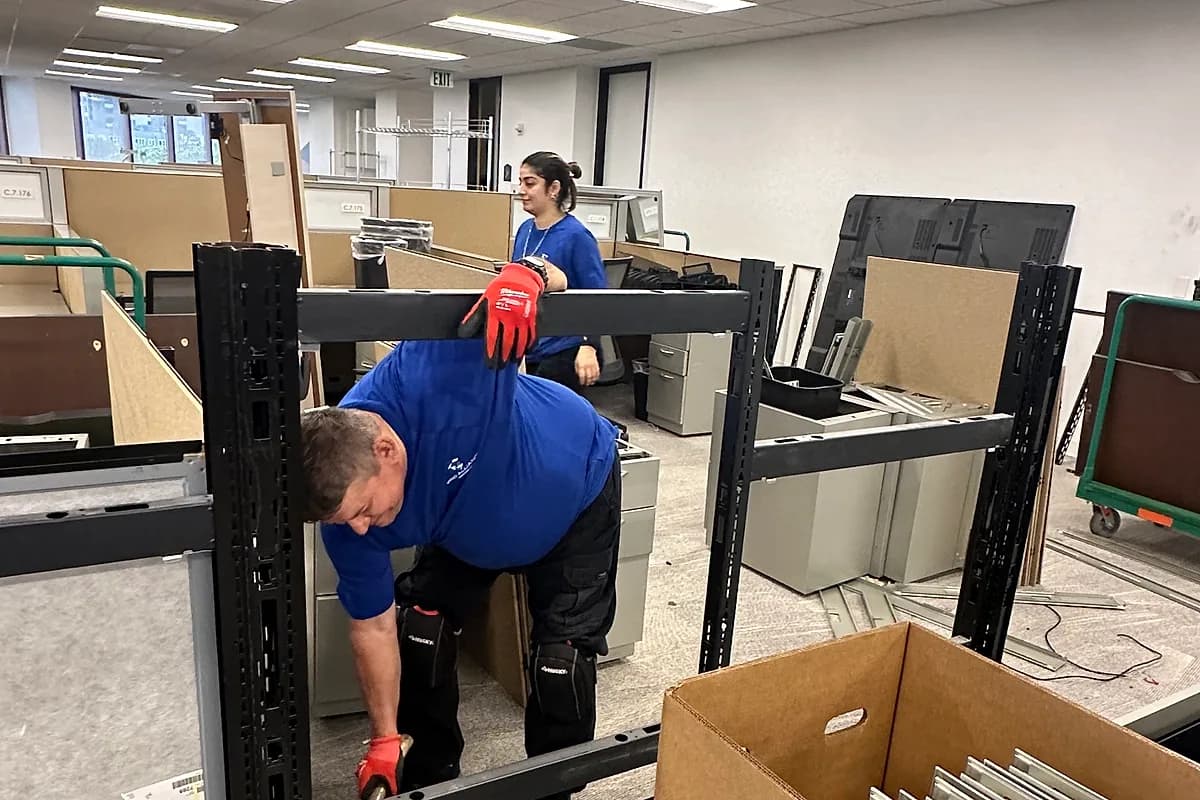 Pro Alliance Services crew breaking down office racking and shelving during a commercial move