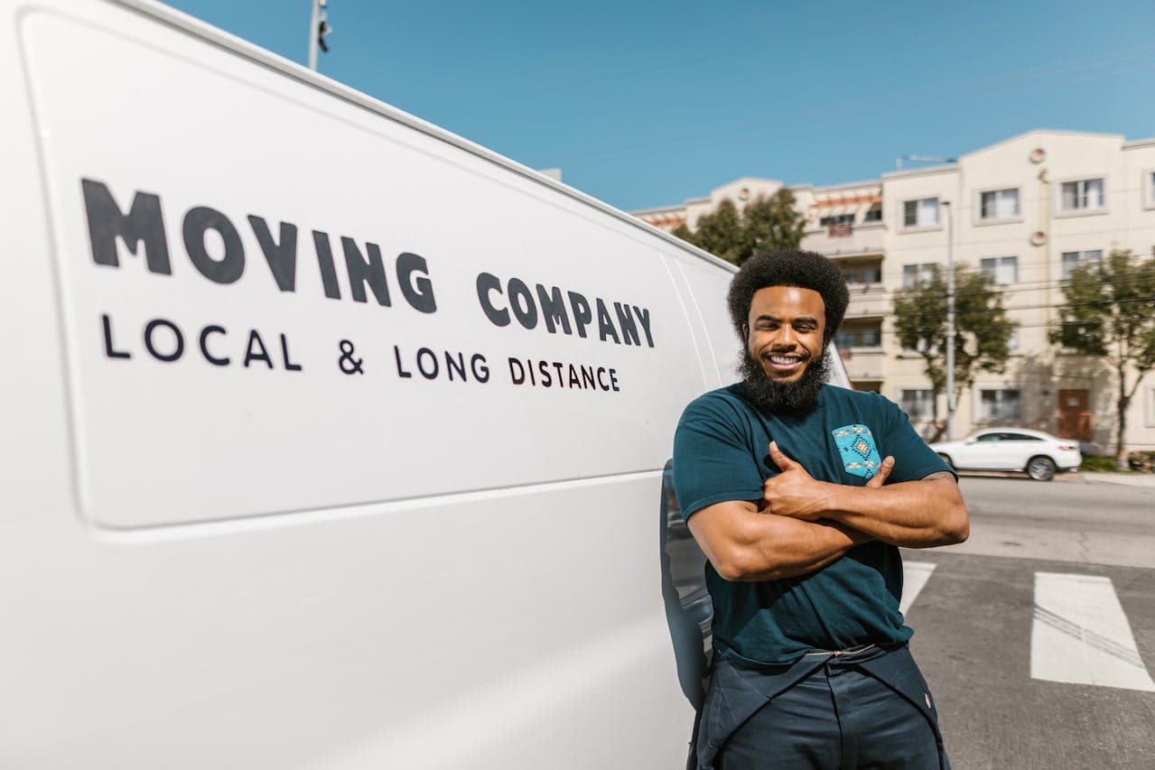 Mover standing by a moving truck.