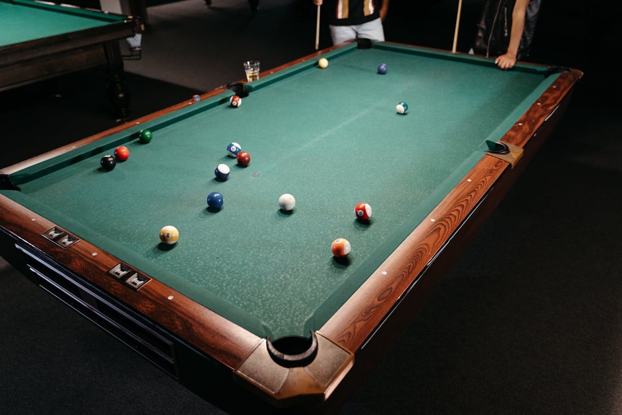 People next to the pool table
