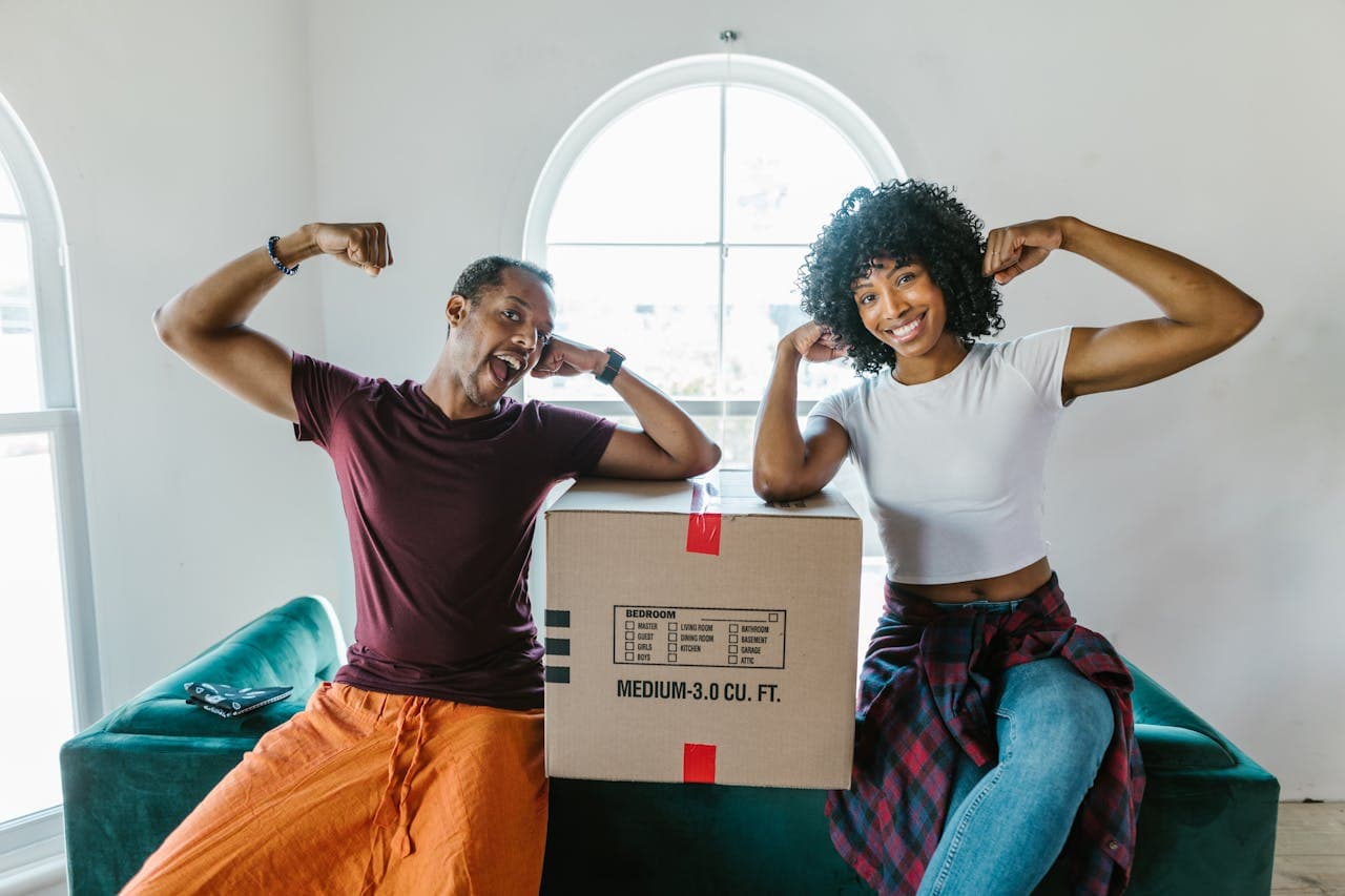 Two people next to the moving box