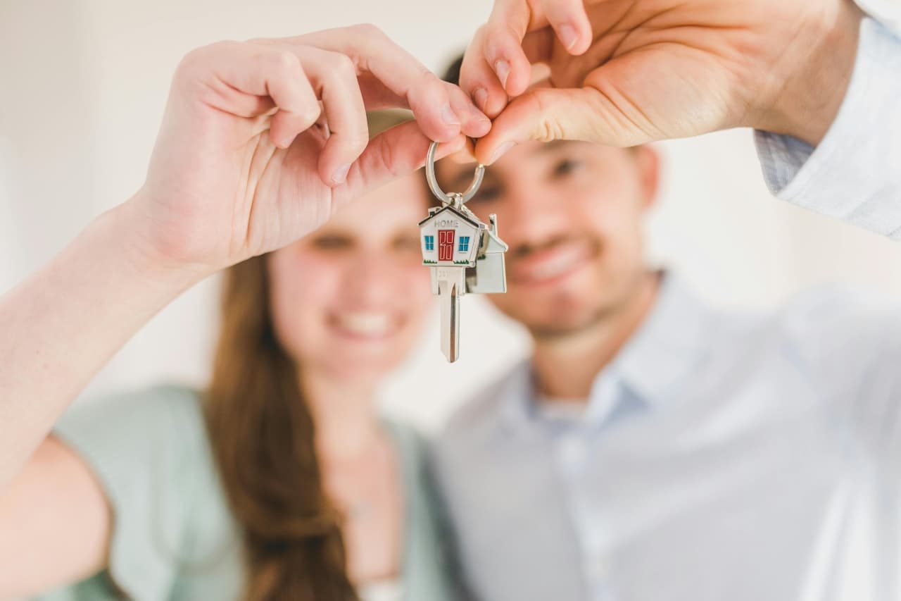 a boy and a girl holding a key