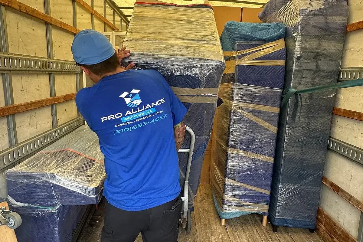A wrapped item strapped to a hand truck