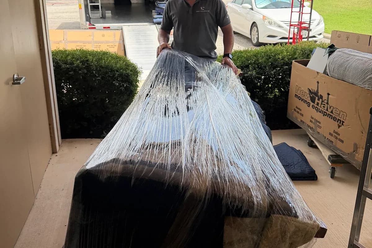 A wrapped furniture item staged before loading