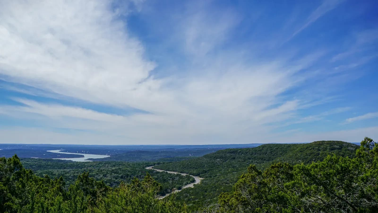 A Texas Hill Country landscape with rolling hills and trees