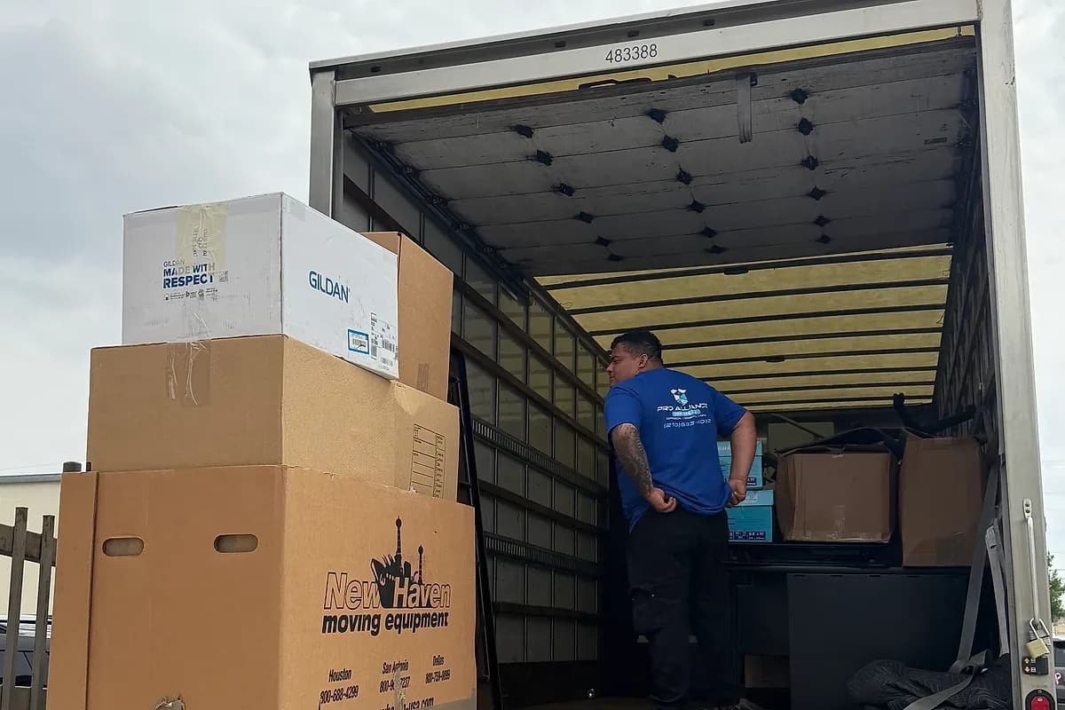 A moving truck being loaded at a property