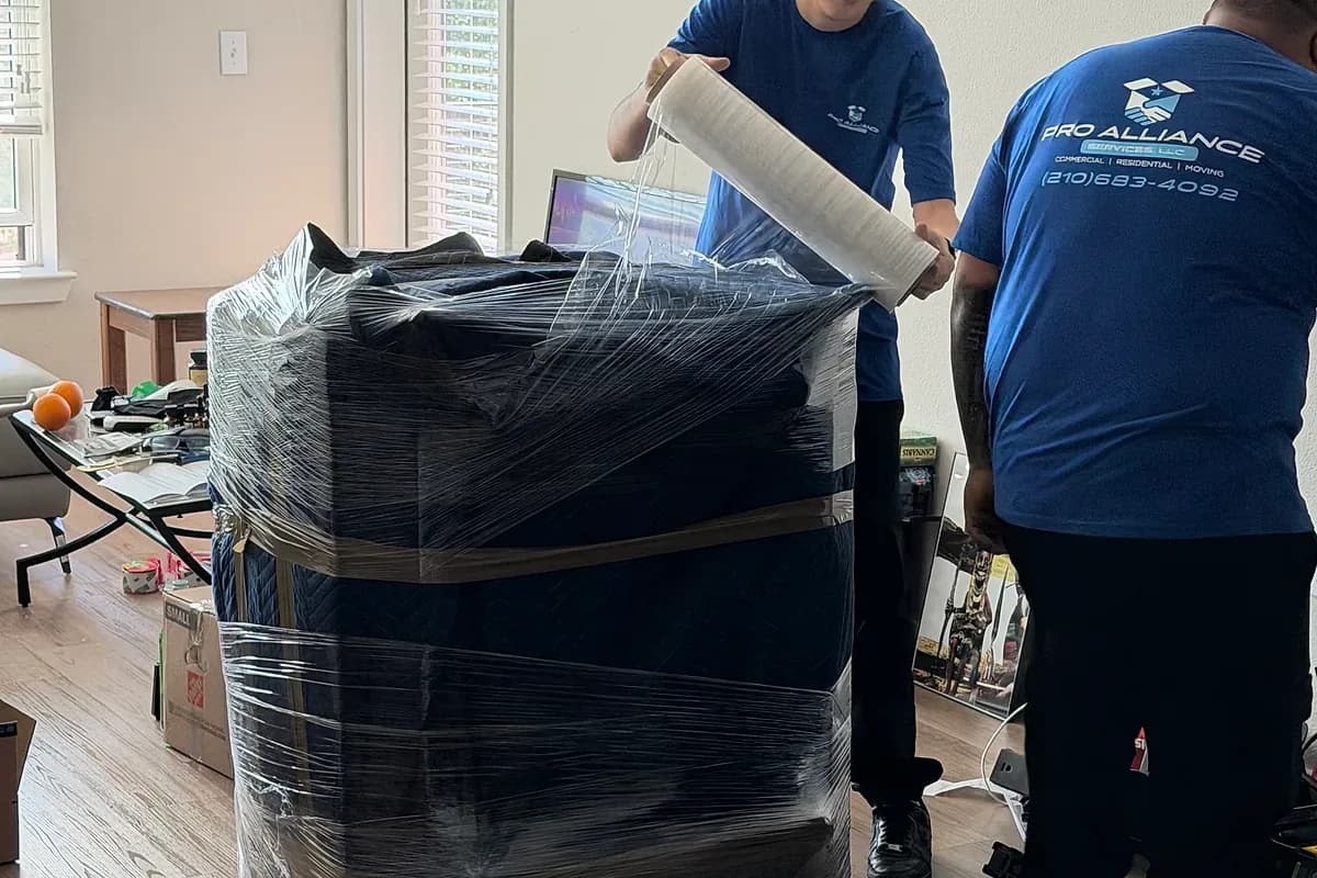 Furniture being shrink-wrapped and staged indoors