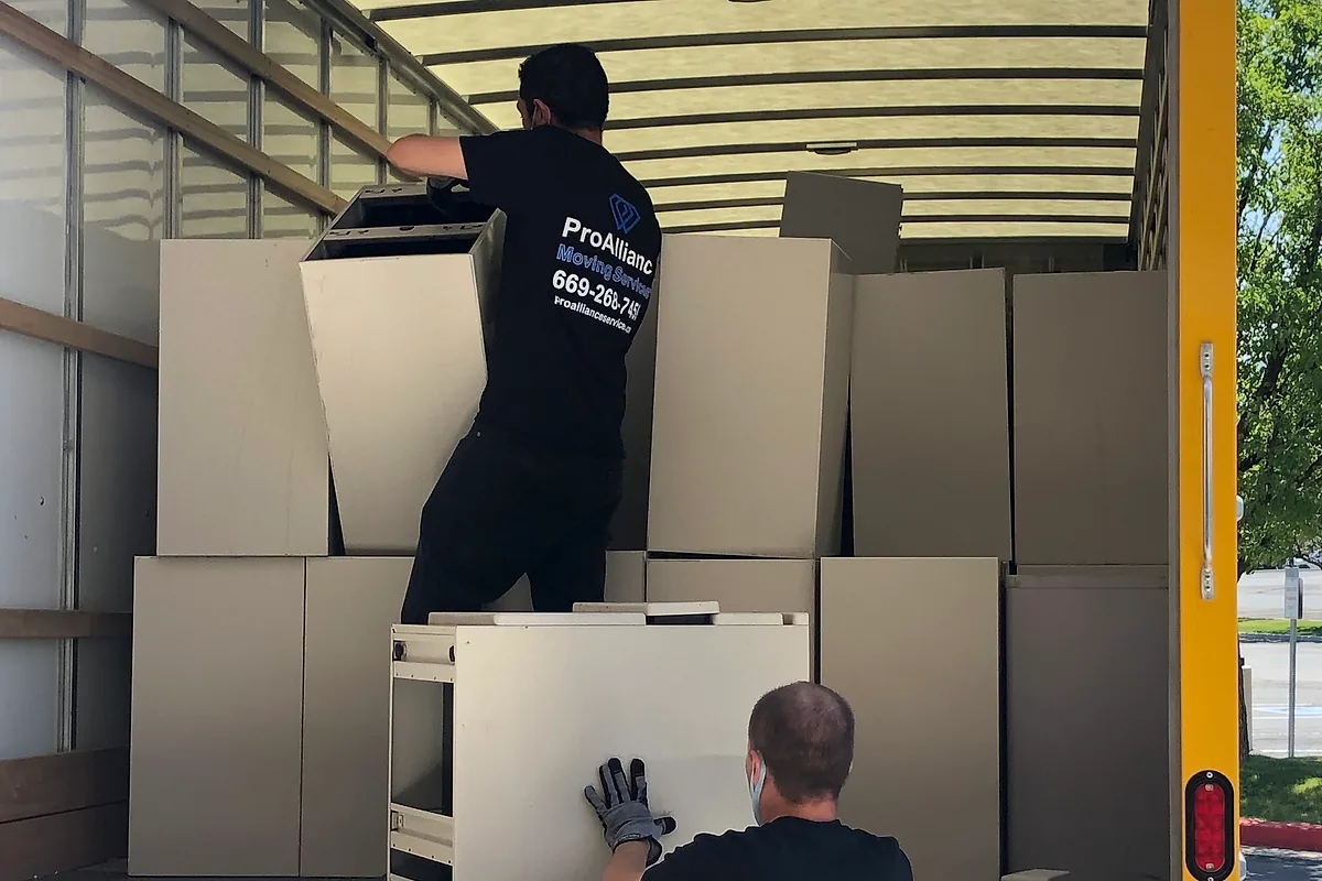 Pro Alliance crew loading office cabinets and equipment into a moving truck