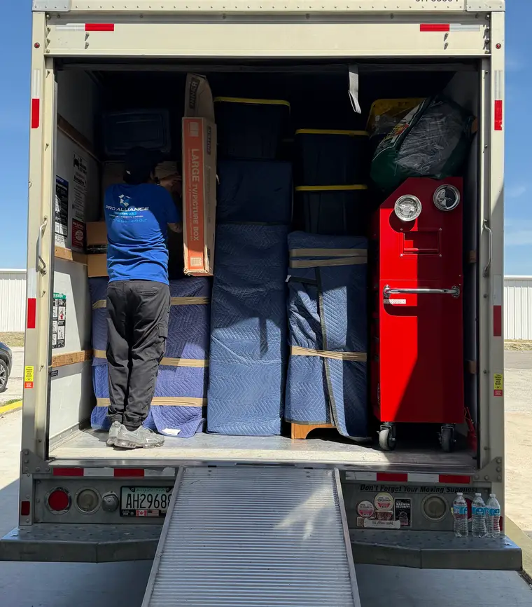 Pro Alliance moving truck loaded with wrapped and strapped furniture