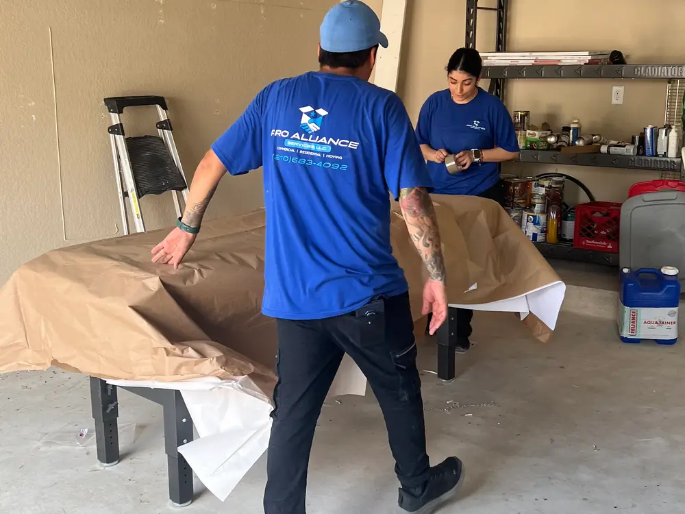 Pro Alliance crew paper-padding furniture before a move