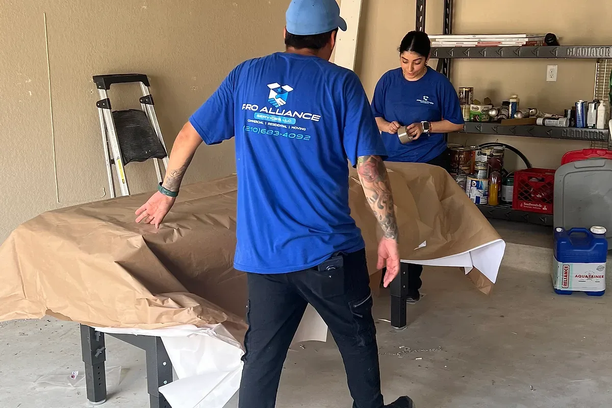 Furniture being wrapped and staged in a garage
