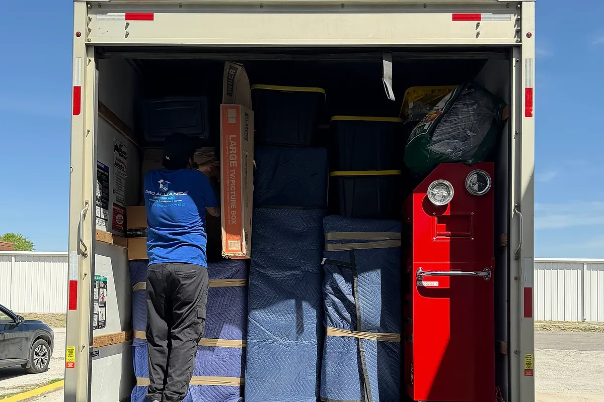 A moving truck with its ramp down at a loading area