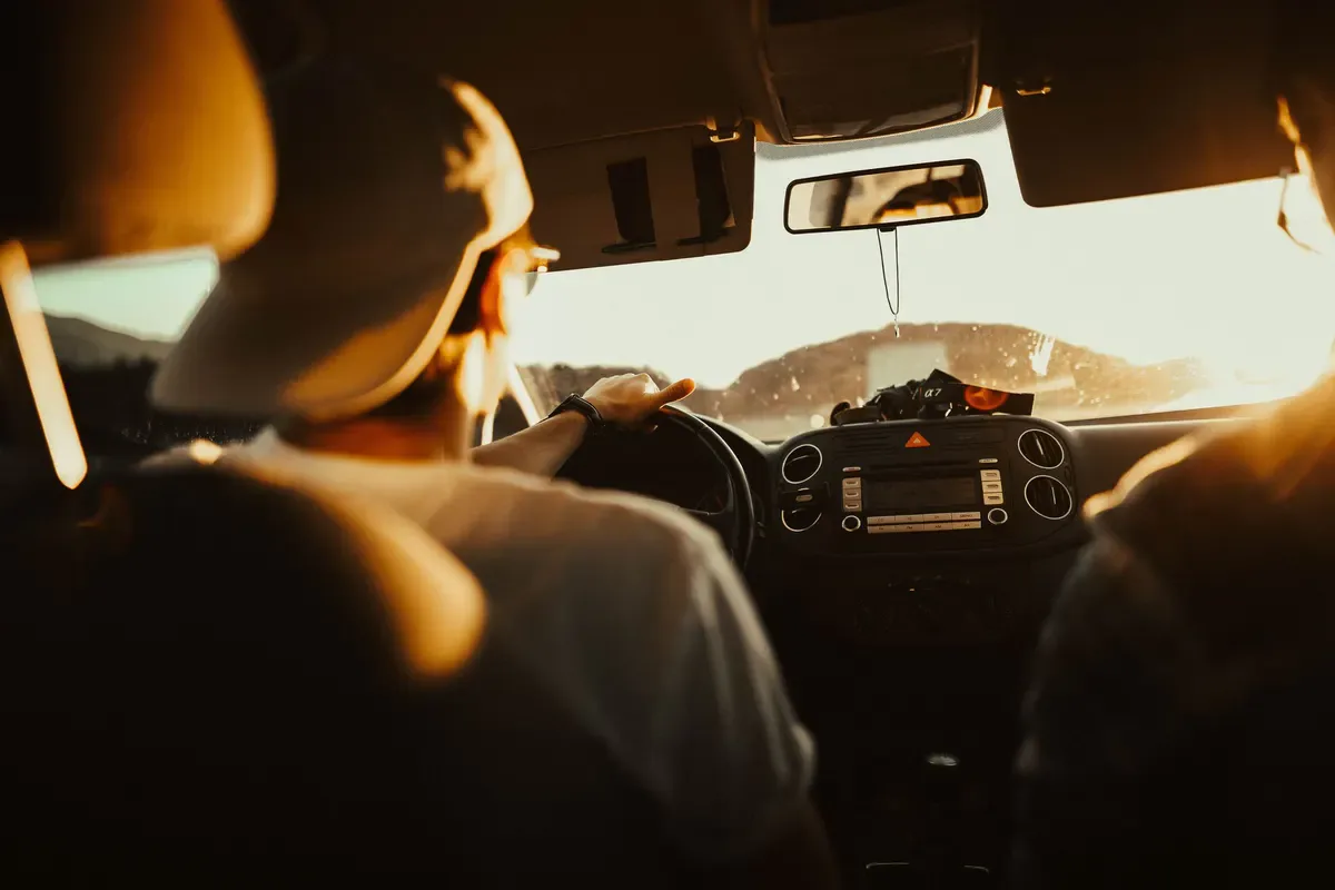 A person reviewing a route on a device in a vehicle