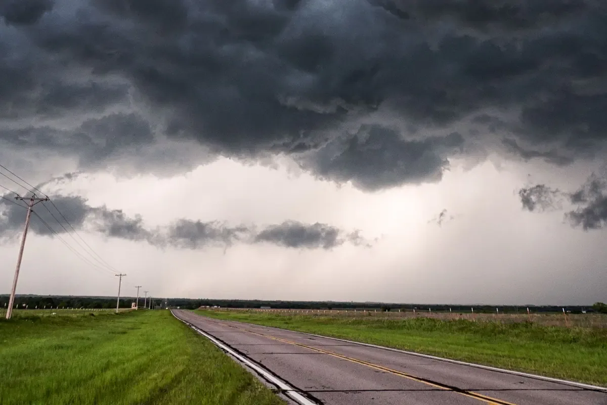 A rural two-lane road in changing weather