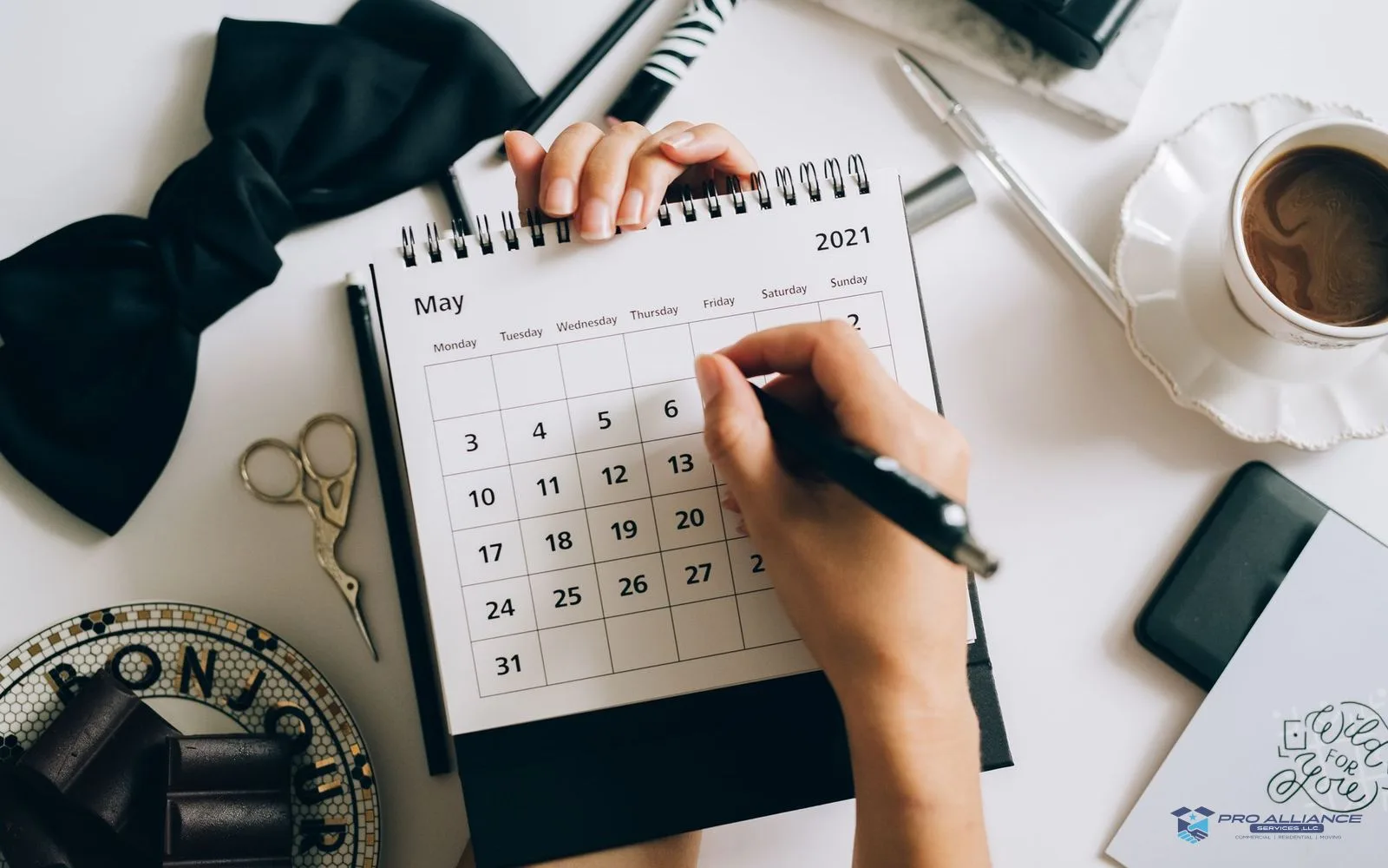 A calendar and planner being used to schedule dates