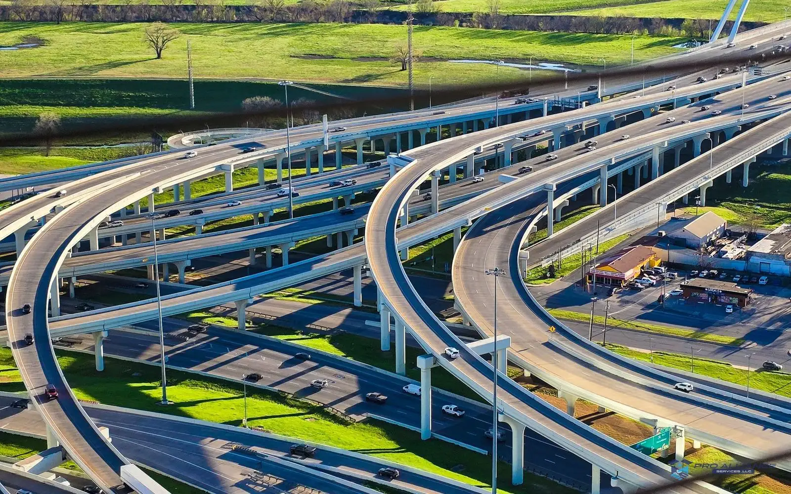 A box truck travels in traffic on a multilane highway