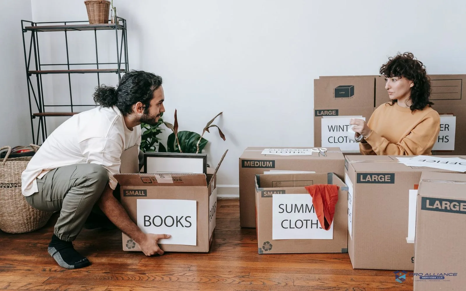 Labeled moving boxes stacked in a living room ready for loading