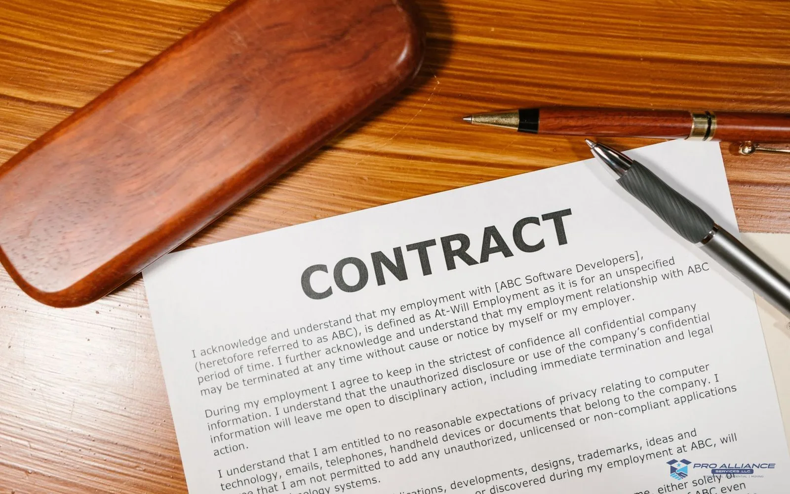 Hands reviewing a moving contract at a table beside packed boxes