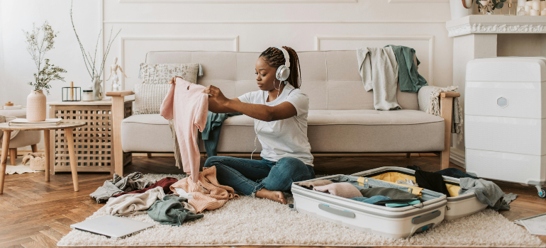 woman packing clothes into a suitcase thinking about packing tips and tricks