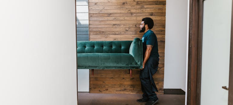 A mover carrying a sofa