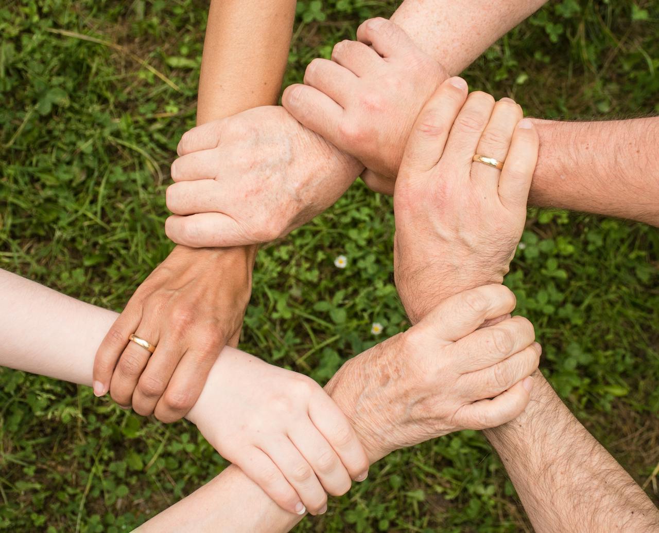 People holding arms trying to build a community after moving to Cibolo