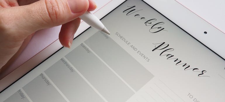 A person writing mistakes to avoid when relocating an office in the planner