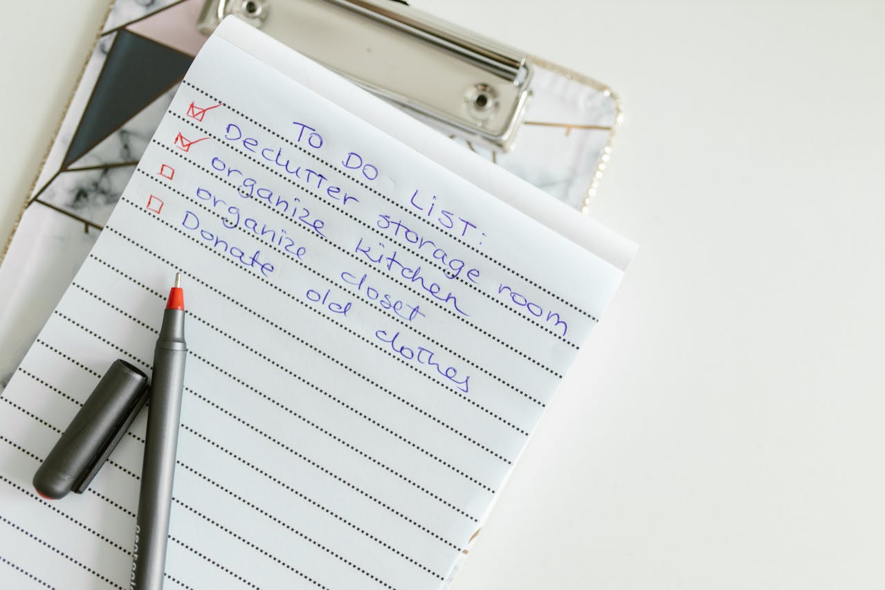 A pen next to the decluttering checklist for moving to Schertz