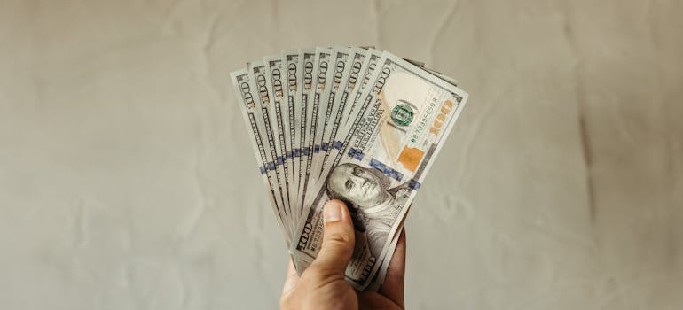 A person holding dollar bills