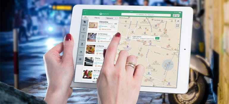 A person using a tablet to find a location to relocate a retail store to San Antonio