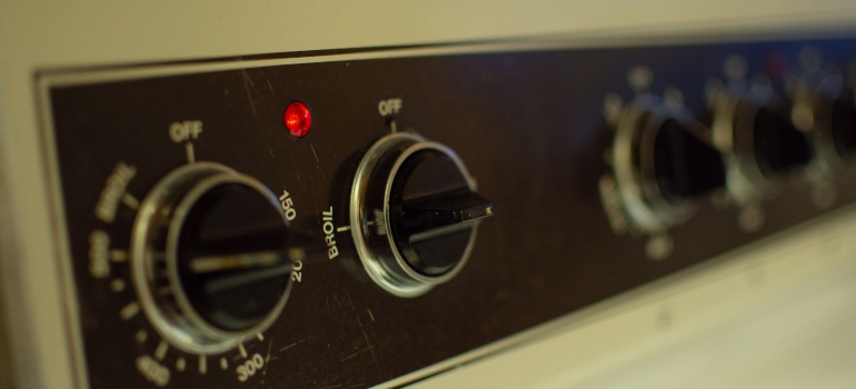 Knobs on a kitchen stove that can be moved with the help of appliance movers San Antonio has