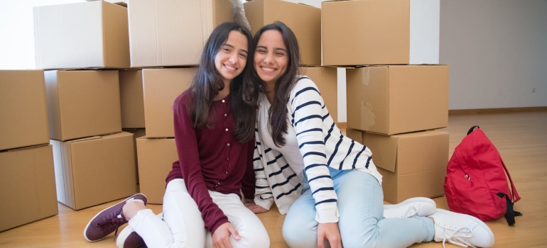 Girls siting in front of boxes