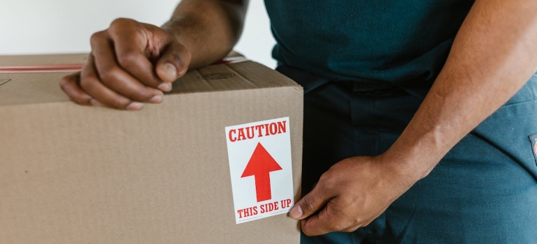 Person labeling a box