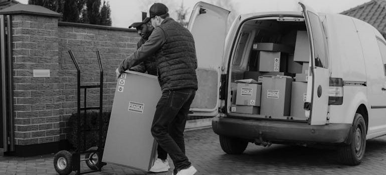 Moving professionals carrying boxes to help you with a same-day move in UValde.