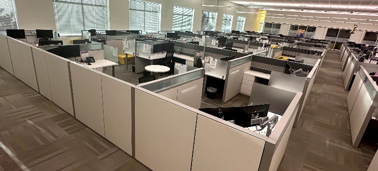 Modern office with many desks and computers organized neatly after professional furniture installation by an expert team.