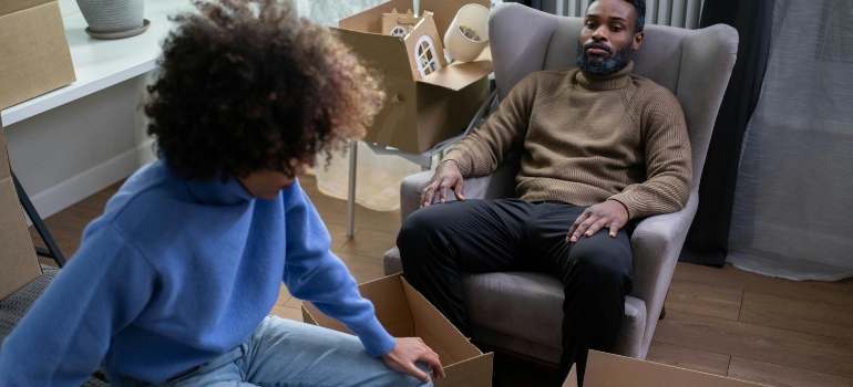 A Woman in Blue Sweater Sitting beside a Man in Brown Sweater