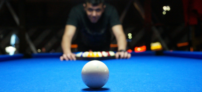 playing billiard on pool table after settling into a new home