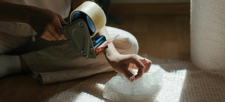 A woman using tape for packing