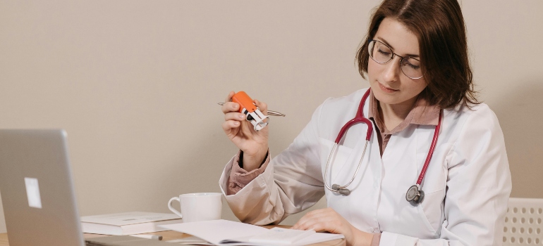 Doctor reviewing documents and preparing to resume operations in a new office.