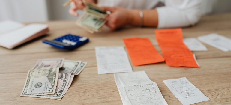 Person Paying Bills After moving to a smaller apartment in San Antonio