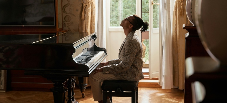 Grand piano positioned in a bright living room after professional relocation.