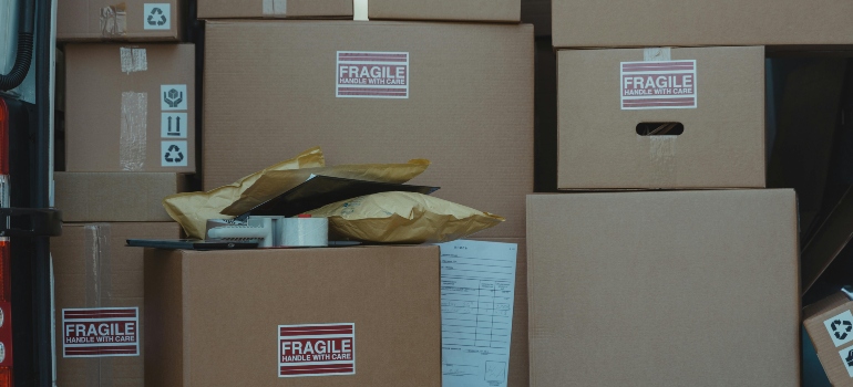 Clearly labeled “Fragile” boxes stacked securely inside a moving truck for safe transport.