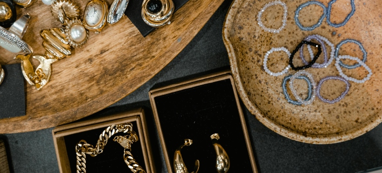 Jewelry items separated in containers to keep them safe during transport.