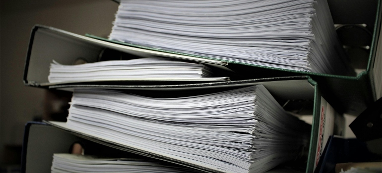 Organized folders with important documents prepared before people pack for a move in 3 days.