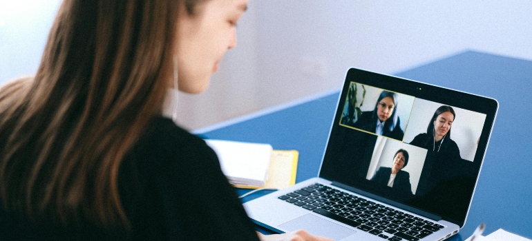 Woman attending a virtual meeting to adjust to moving to a small town and maintain communication