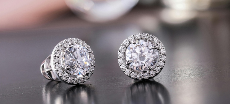 Diamond earrings placed safely as part of steps to pack jewelry for a move.