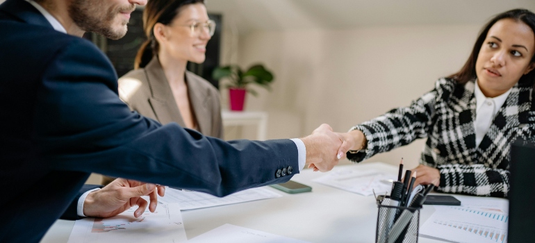 Professionals finalizing a new job contract that requires relocation and preparation to pack for a move in 3 days.